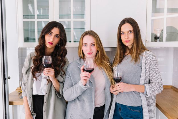 Three women holding wine glasses