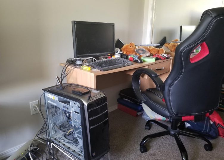 An expensive gaming chair at an unseemly messy desk