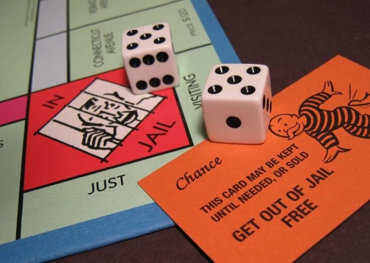 "Jail" space on Monopoly board with dice