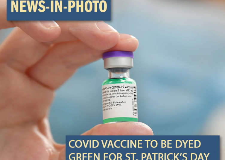 A vial of the COVID vaccine, dyed green.