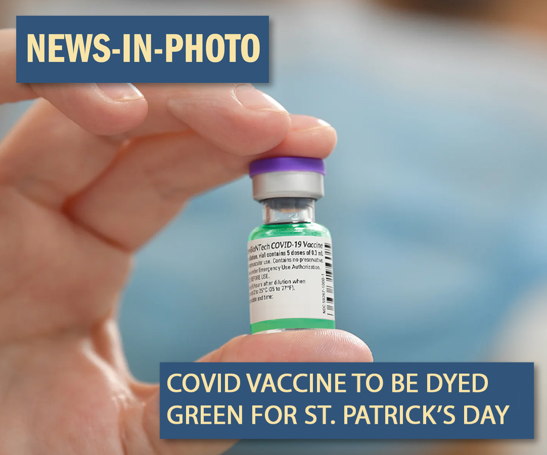A vial of the COVID vaccine, dyed green.