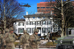 The military stands outside President Schlissel's house.
