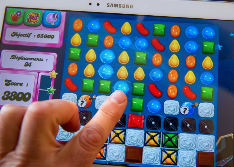 An elderly woman on a difficult Candy Crush level