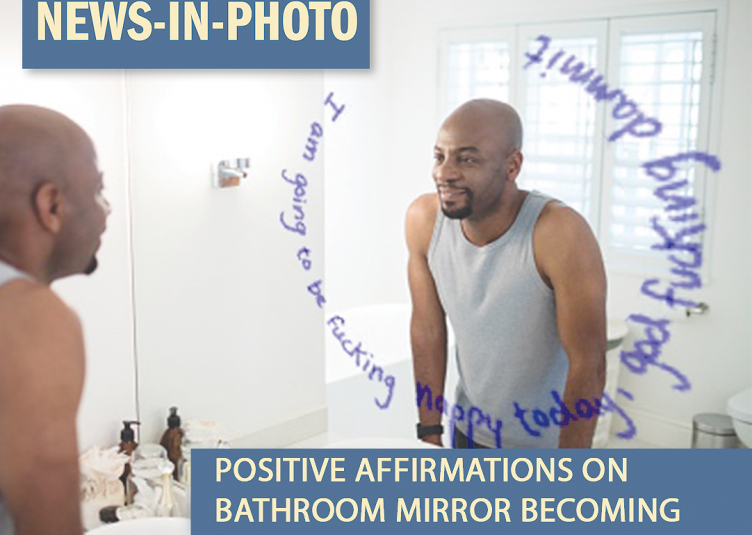 Man standing in from the of a mirror that reads "I am going to be fucking happy today, god fucking damnit".