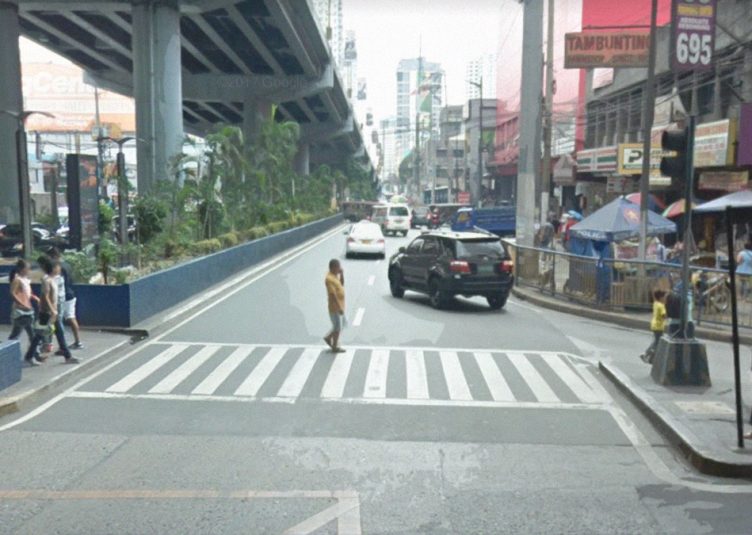 Man walking in middle of crosswalk in city