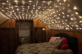 Image of bright fairy lights filling a bedroom.