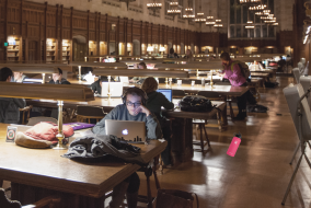 Picture of students studying in the Law Library with a single hydroflask dropped on the floor.