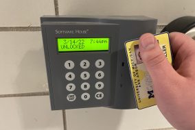 Person holding card up to card scanner