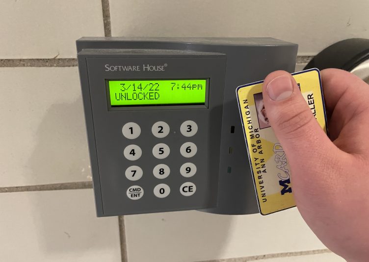 Person holding card up to card scanner