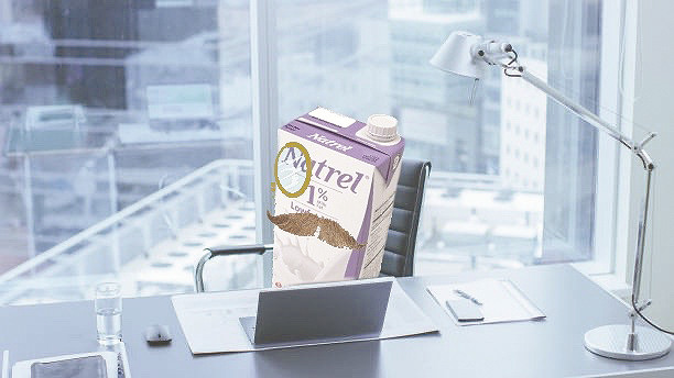 Oat Milk sitting in a fancy high rise with a fancy moustache and monocle