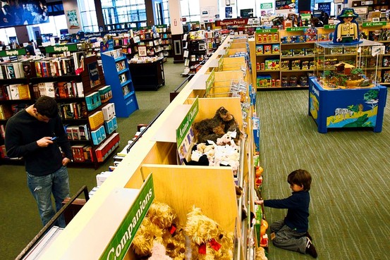 child looking at toys in a barnes and noble