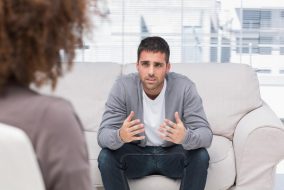 Image of a guy named bill being consoled on a couch by a therapist.
