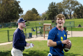 Jim Harbaugh and a football player wearing a dog collar.