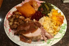 a thanksgiving plate with food toughing other food