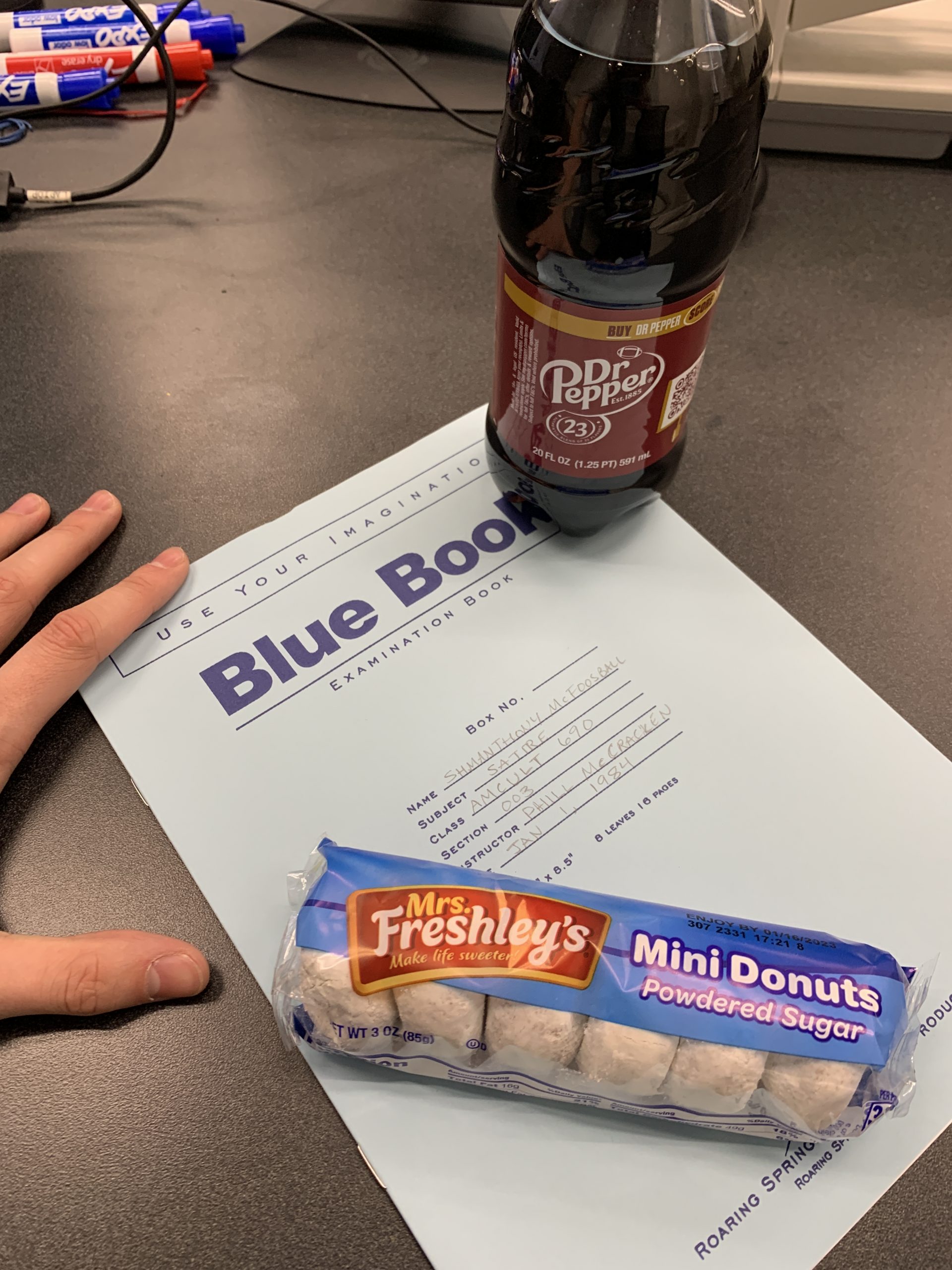 Schmanthony McFooseball's blue book along with assorted snacks.