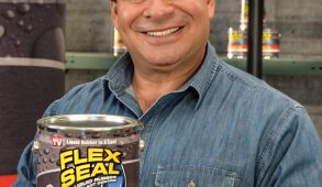 A man in a denim shirt holds up a can of liquid Flex Seal.