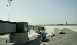A jet bridge is seen with no plane at the end of it.