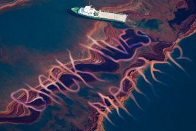 Ocean with a cruiser driving through an oil spill spelling "black lives matter"