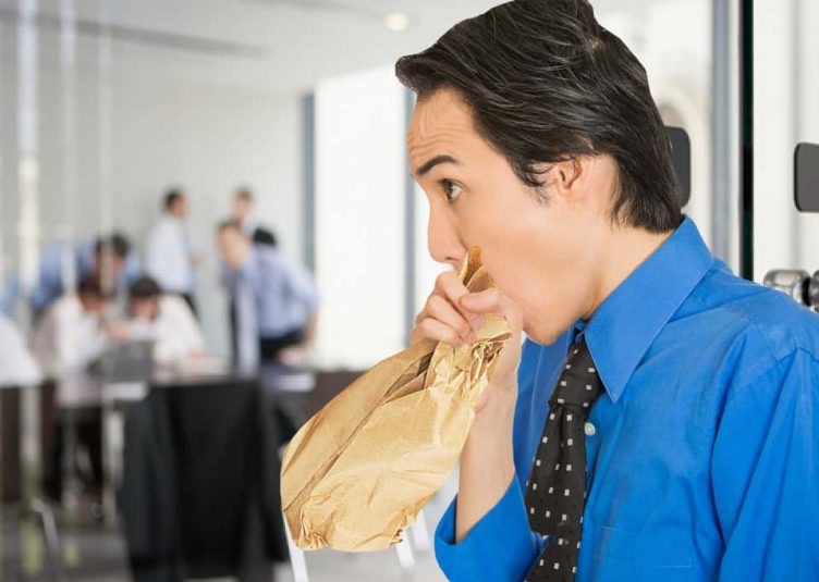 Man breathing into a paper bag frantically