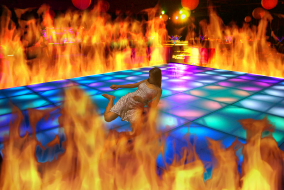 Shawty lies on a dance floor surrounded by flames.