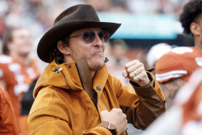 Matthew McConaughey looking excited and wearing a cowboy hat