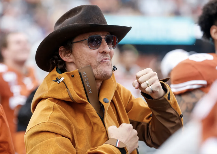Matthew McConaughey looking excited and wearing a cowboy hat