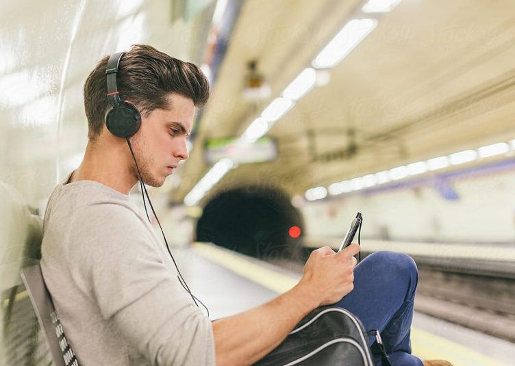 Man with headphones sitting on bench
