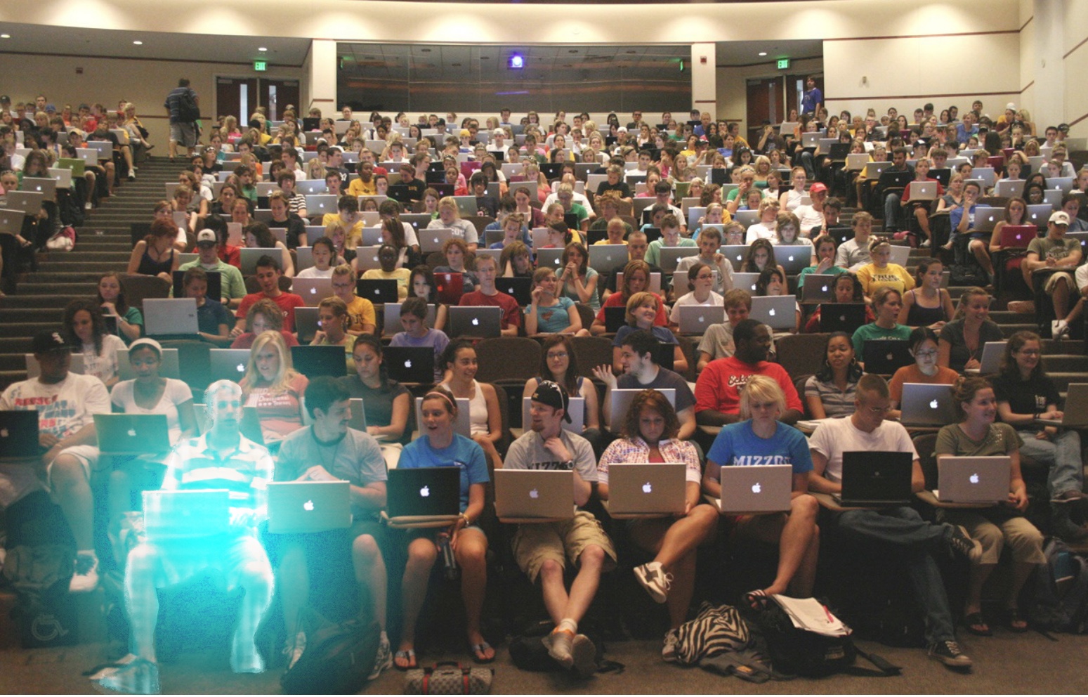 Photoshopped holographic student sitting in lecture hall among many real students