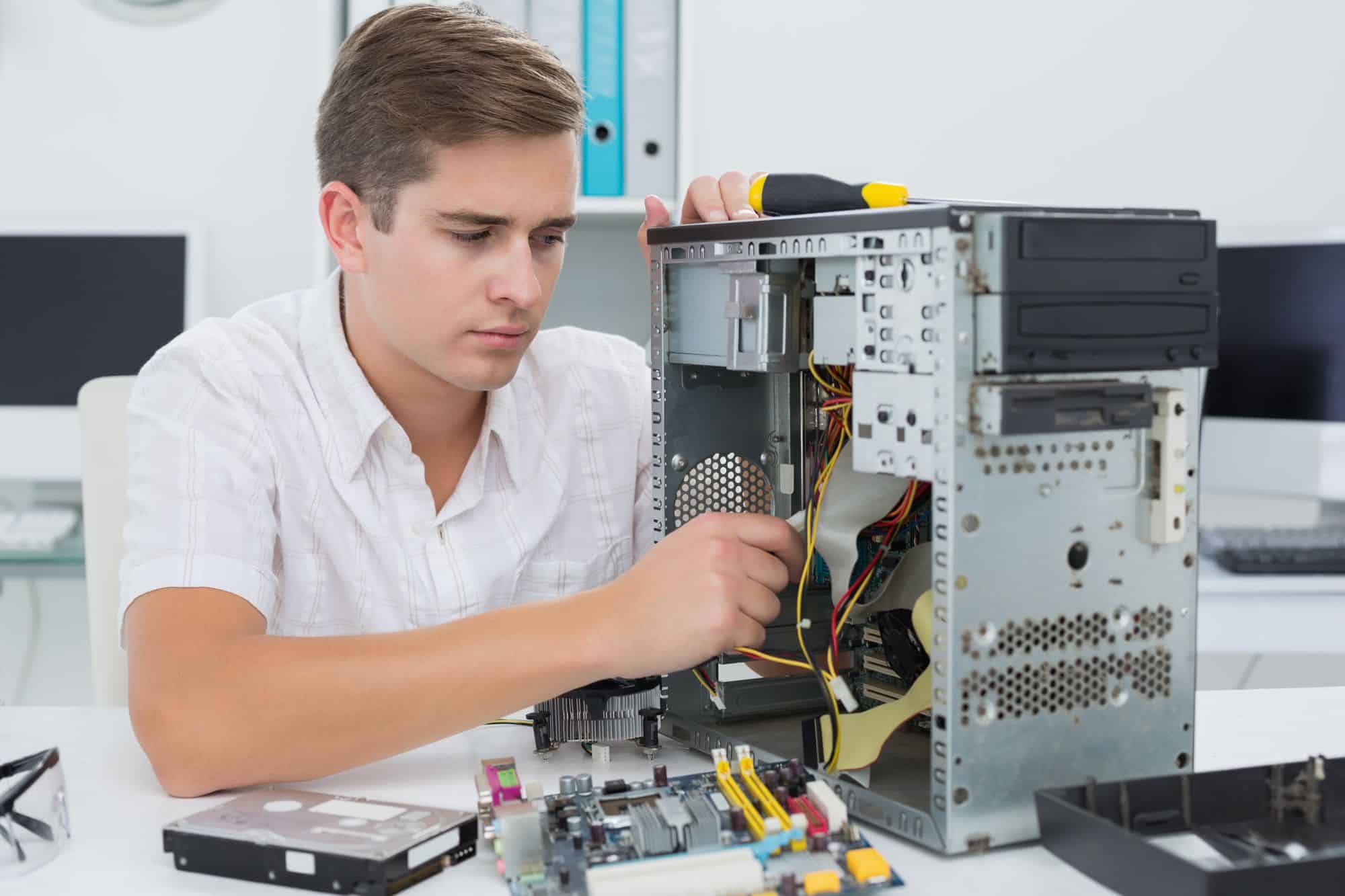 An IT guy fixing a computer.