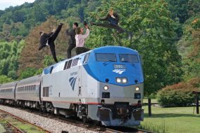 Photoshopped people skirmishing atop moving train