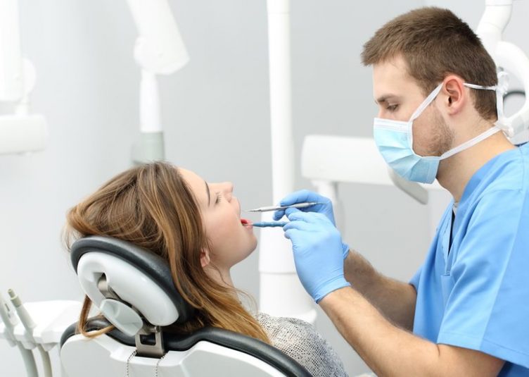 Dentist looking at a persons teeth