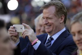 Roger Goodell taking a photo.