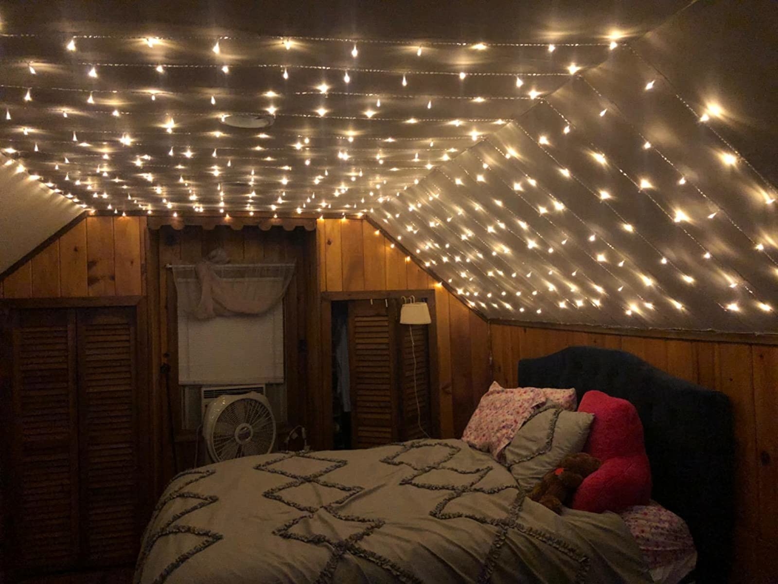 Image of bright fairy lights filling a bedroom.