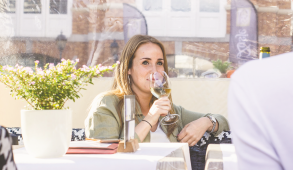woman nervously sipping wine