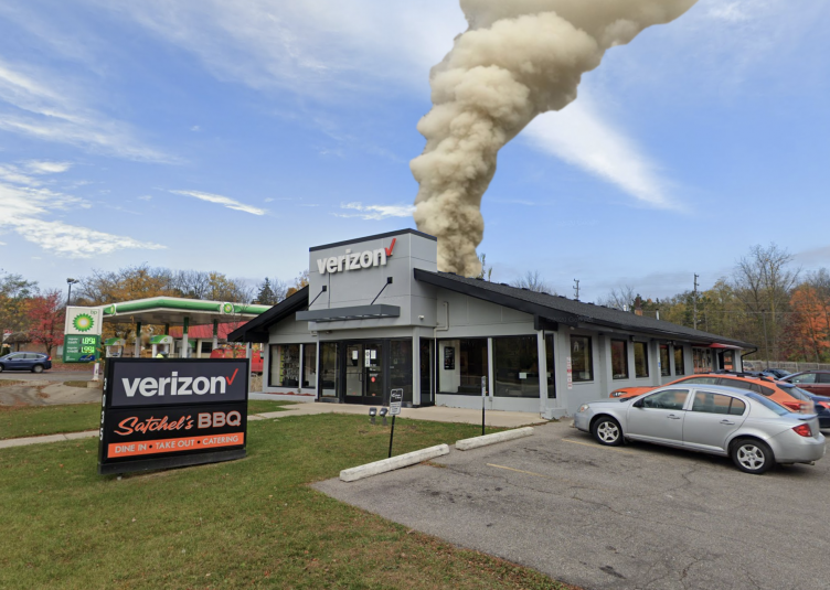 Photoshopped smoke on coming from building with sign in front saying "Verizon" and "Satchel's BBQ"