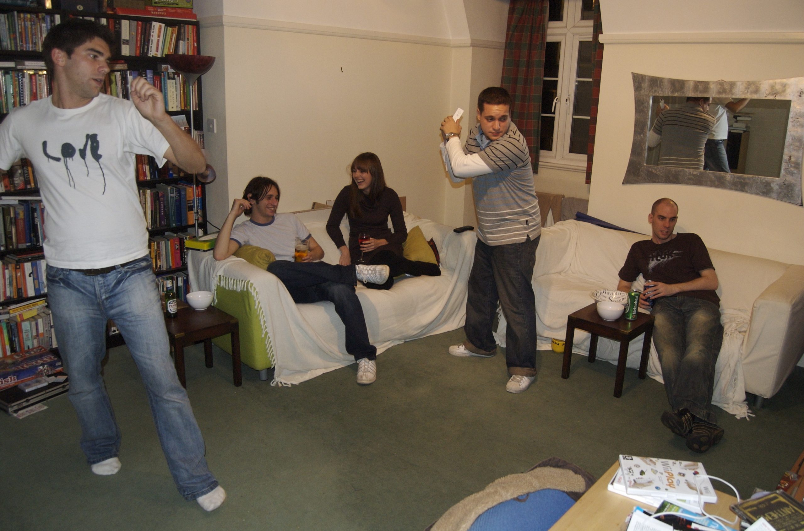 A group of guys playing Wii Sports.