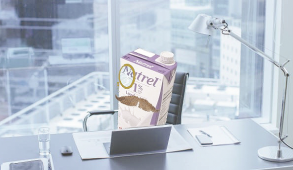 Oat Milk sitting in a fancy high rise with a fancy moustache and monocle