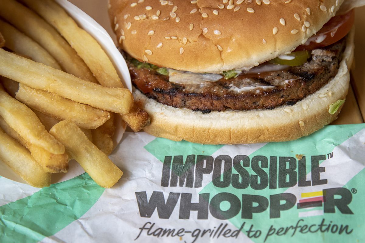 Impossible Whopper and fries on sit on a labeled wrapper