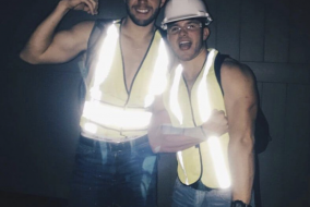 Two men wearing construction worker costumes