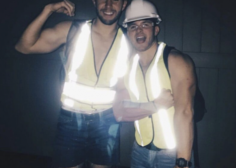 Two men wearing construction worker costumes