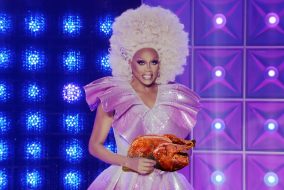 RuPaul holding a Turkey that he slayed.