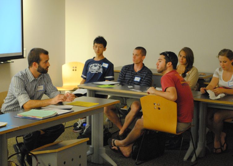 Graduate student leading discussion of college students