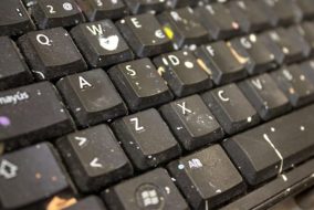 A laptop keyboard covered in crumbs.