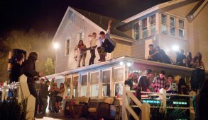 Students partying outside of a house.