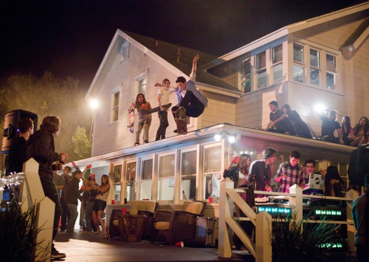 Students partying outside of a house.
